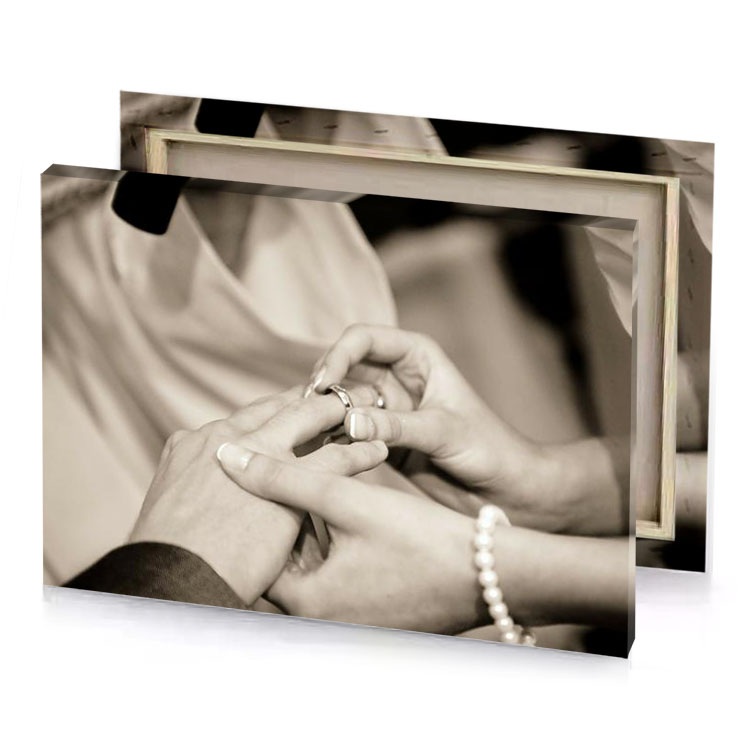 a man and woman holding hands while they are putting silver canvas