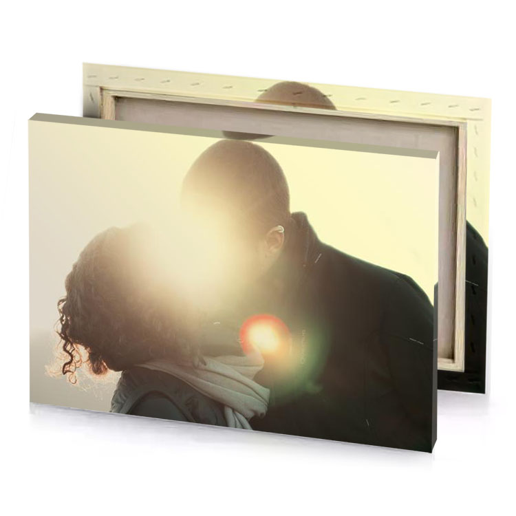 a man and woman kissing in the sun tan canvas