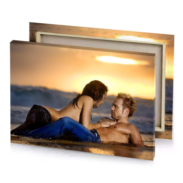 a man and woman laying on the beach charcoal canvas