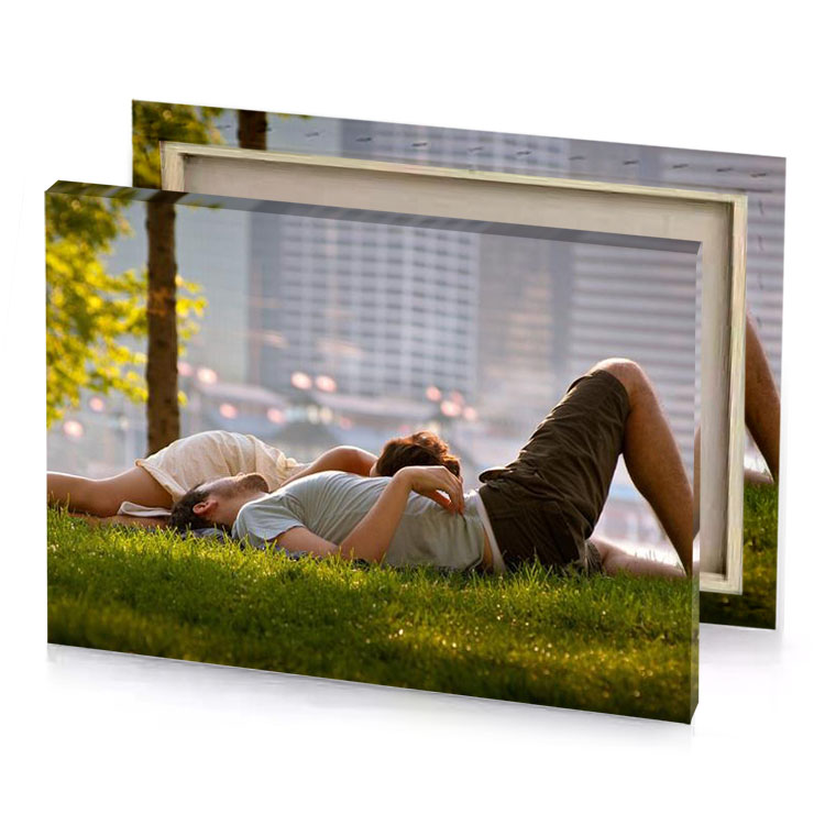 a man and woman laying on the grass rose quartz canvas