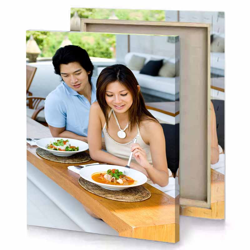 a man and woman sitting at table eating food silver canvas