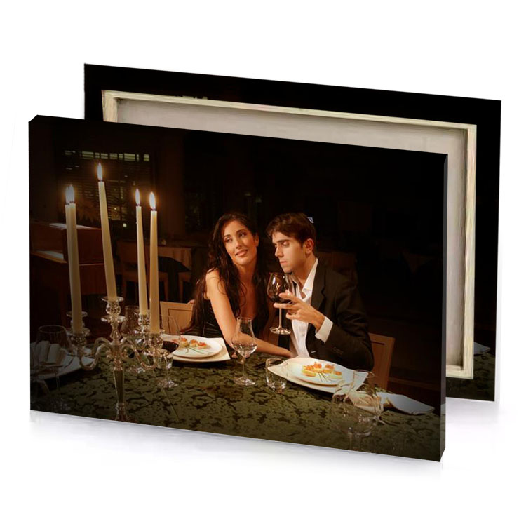 a man and woman sitting at table with candle smoky black canvas