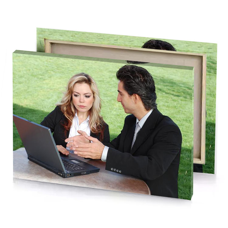 a man and woman sitting at table with laptop celadon canvas