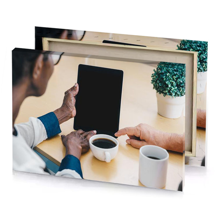 a man and woman sitting at table with tablet smoky black canvas