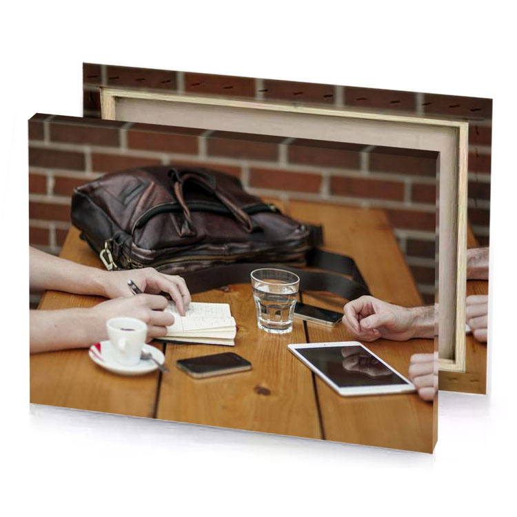 a man and woman sitting at table with tablet zinnwaldite brown canvas