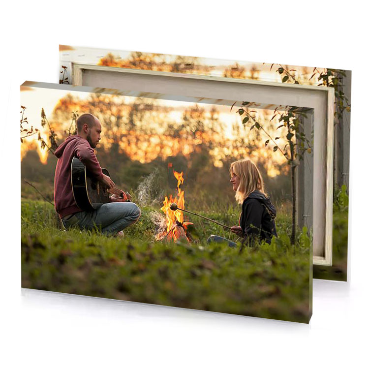 a man and woman sitting by fire sand brown canvas