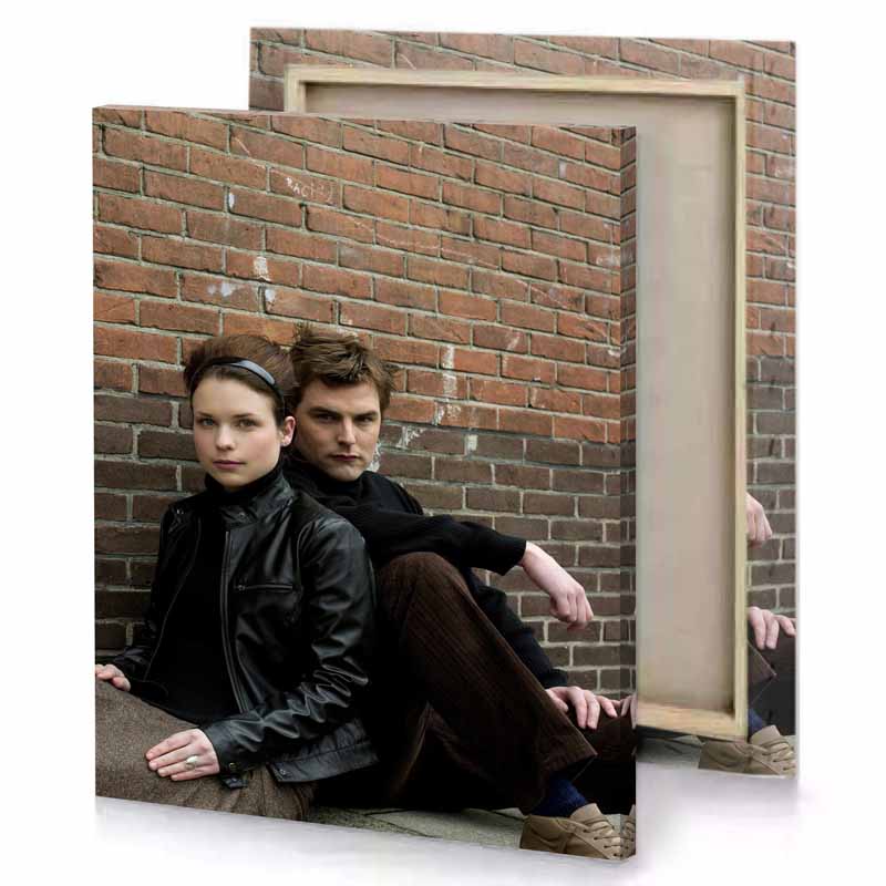 a man and woman sitting on brick wall camouflage green canvas