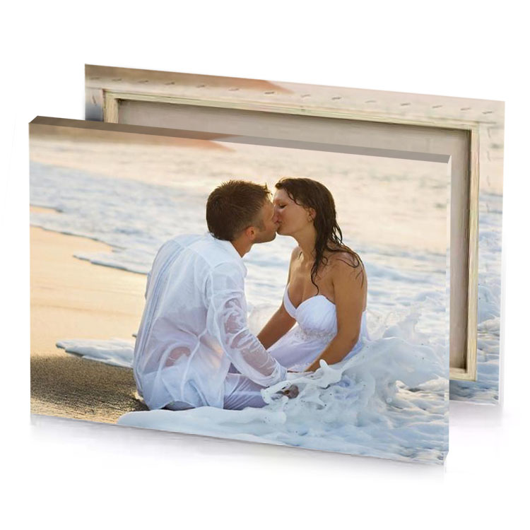 a man and woman sitting on the beach silver canvas