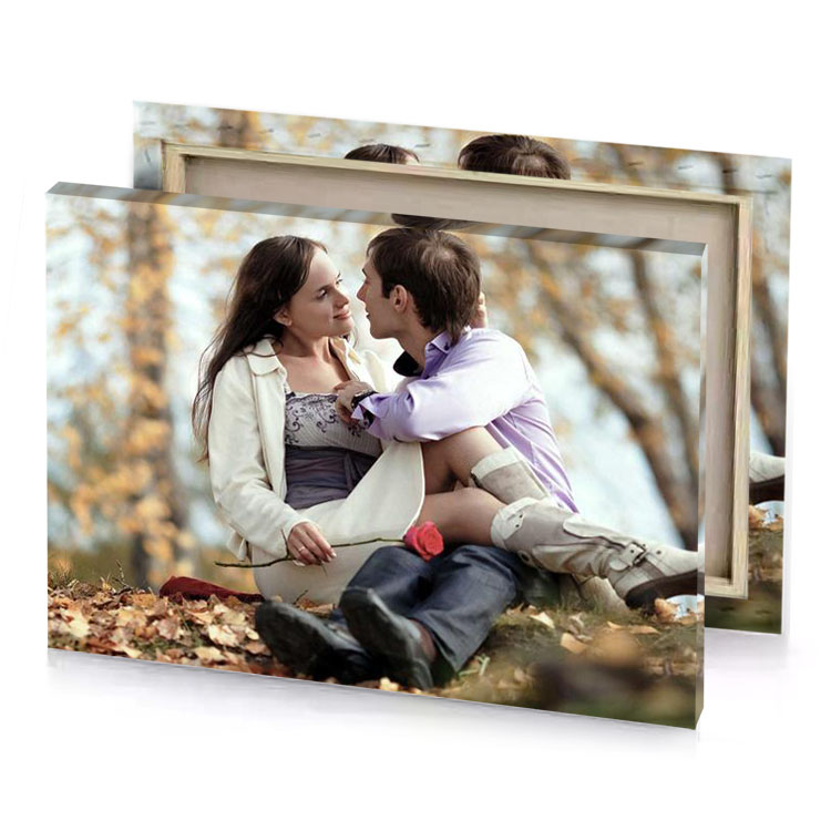a man and woman sitting on the ground in fall platinum canvas