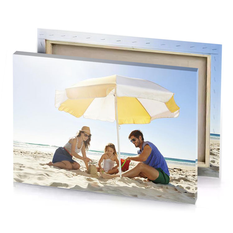 a man and woman sitting under an umbrella on the khaki canvas