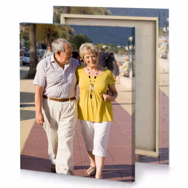 a man and woman walking down sidewalk tan canvas