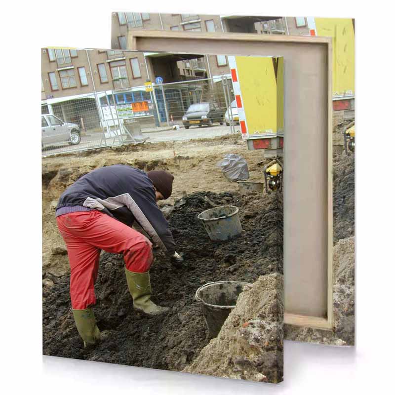 a man digging dirt in construction site brown canvas