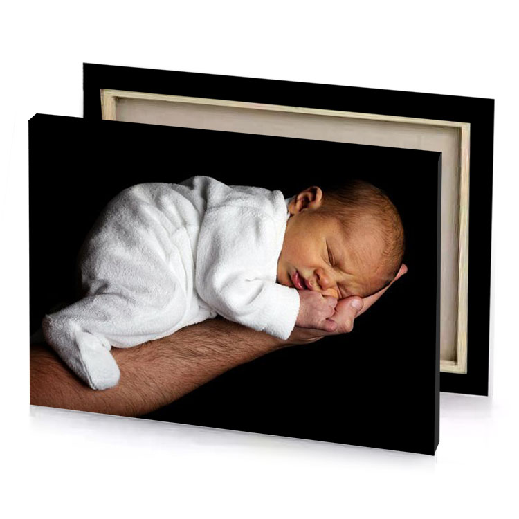 a man holding baby wrapped in towel white smoke canvas