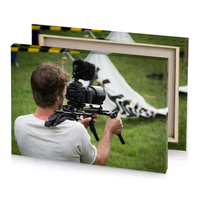 a man holding camera in front of tent smoky black canvas