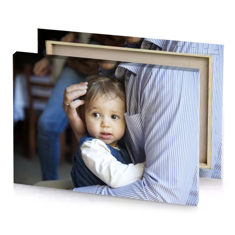 a man holding small child in his arms light steel blue canvas