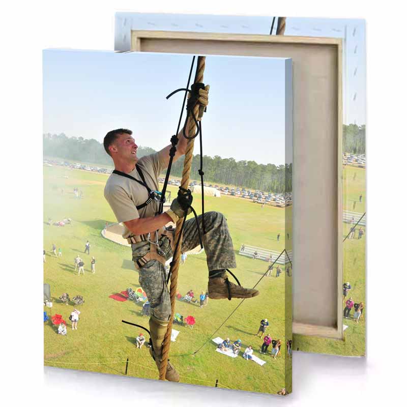 a man in camouflage gear is hanging on rope tan canvas