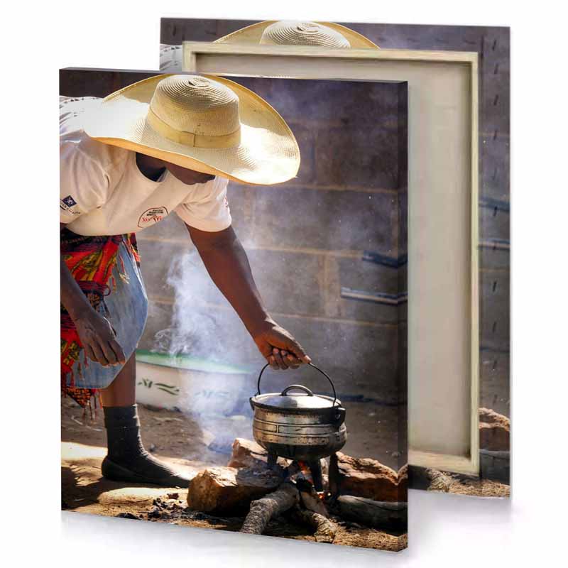 a man in straw hat cooking food on grill light steel blue canvas