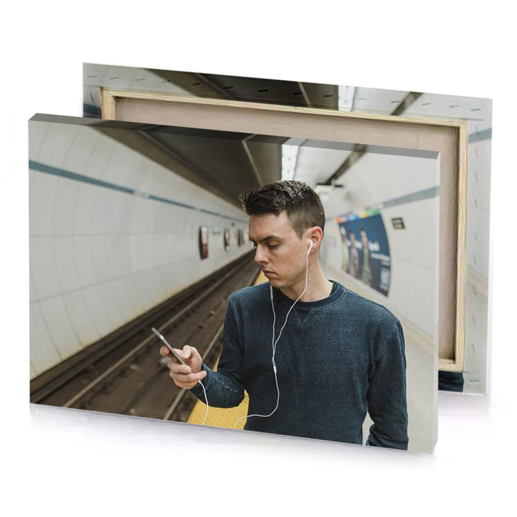 a man in subway station looking at his cell silver canvas