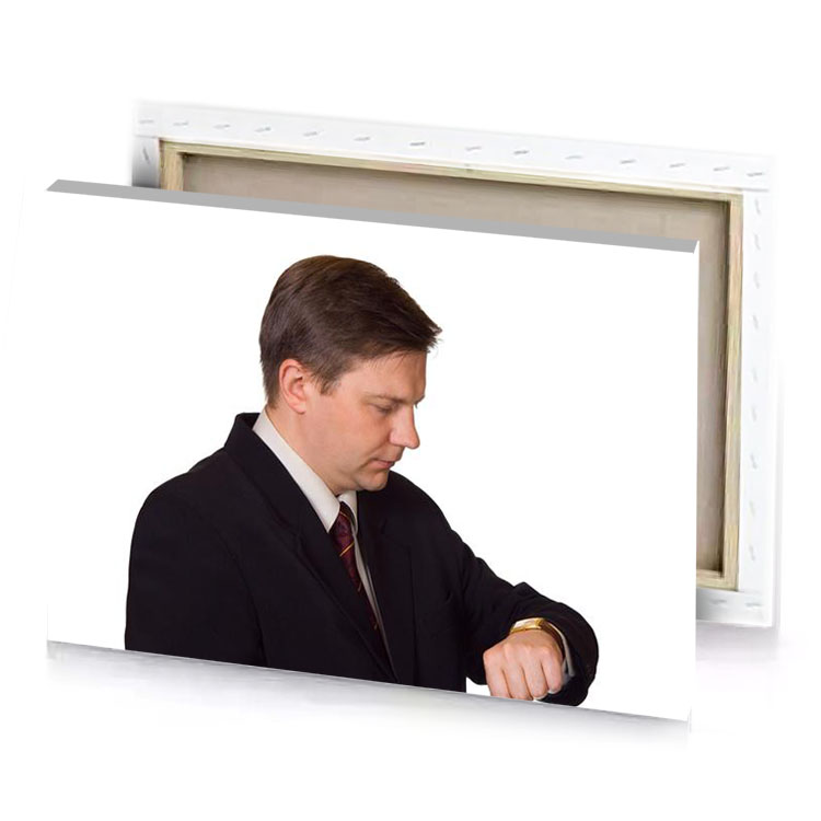 a man in suit and tie is looking down white canvas