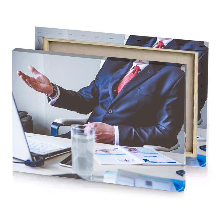a man in suit and tie sitting at desk dim gray canvas
