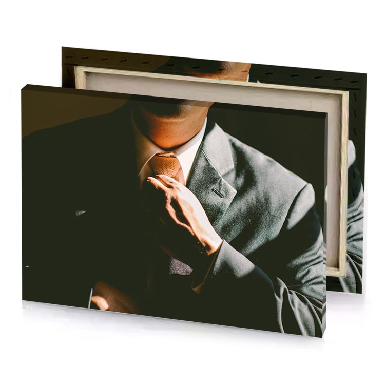a man in suit and tie tying his peach canvas