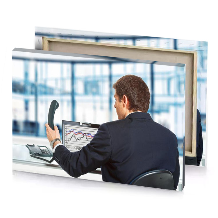 a man in suit sitting at desk with laptop and taupe canvas