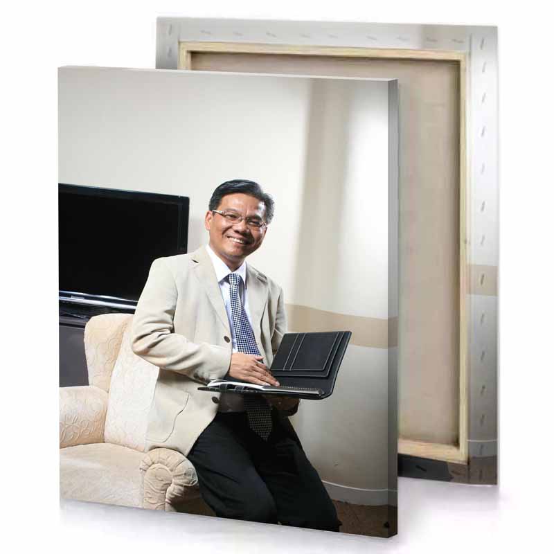 a man in suit sitting on couch with laptop platinum canvas