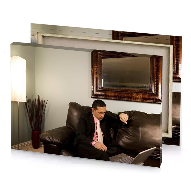a man in suit sitting on couch with laptop silver canvas