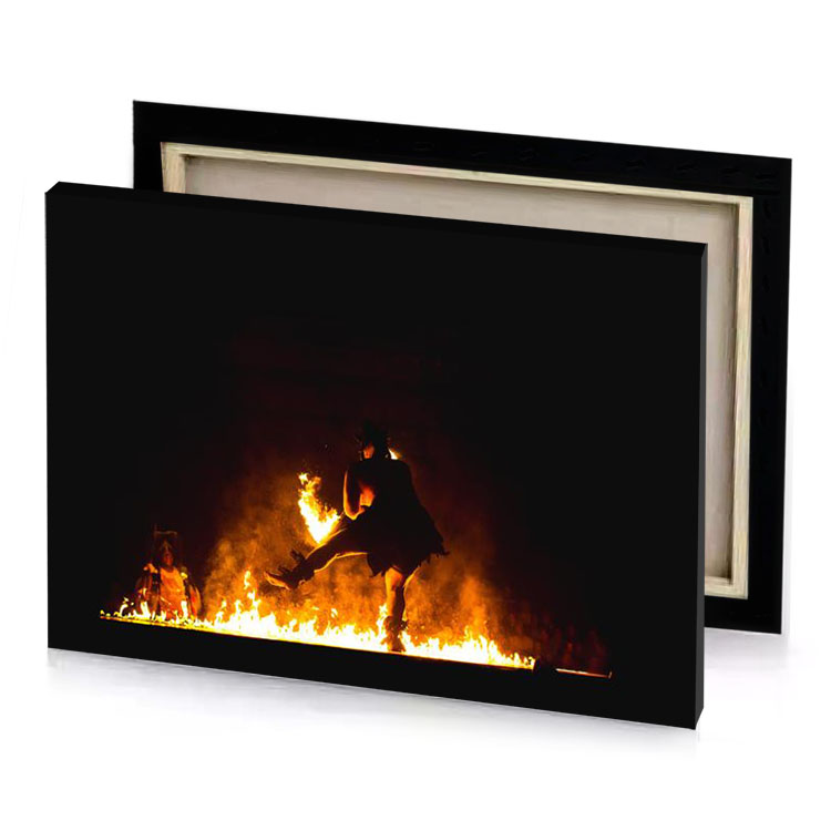 a man is jumping over fire saddle brown canvas