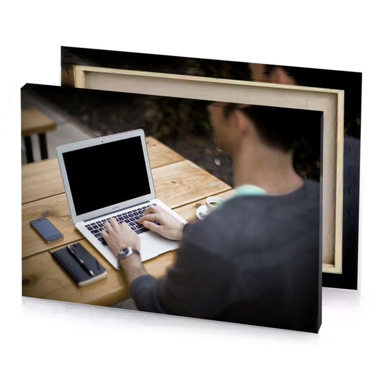 a man is typing on laptop computer tan canvas