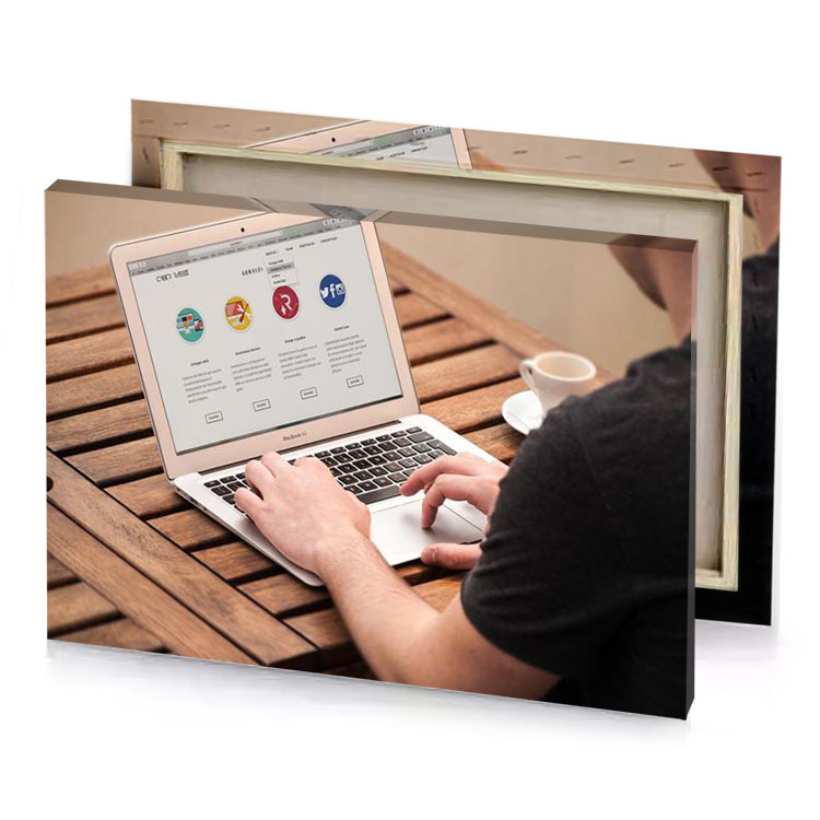 a man is typing on laptop wooden table smoky black canvas
