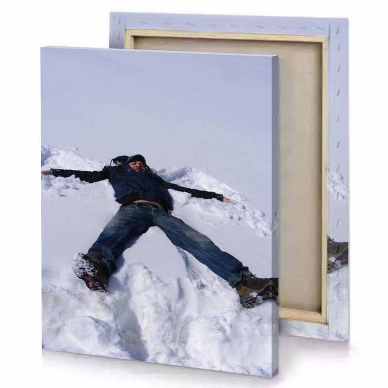 a man laying in the snow with his arms out smoky black canvas
