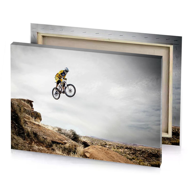 a man on bike jumping off rock platinum canvas