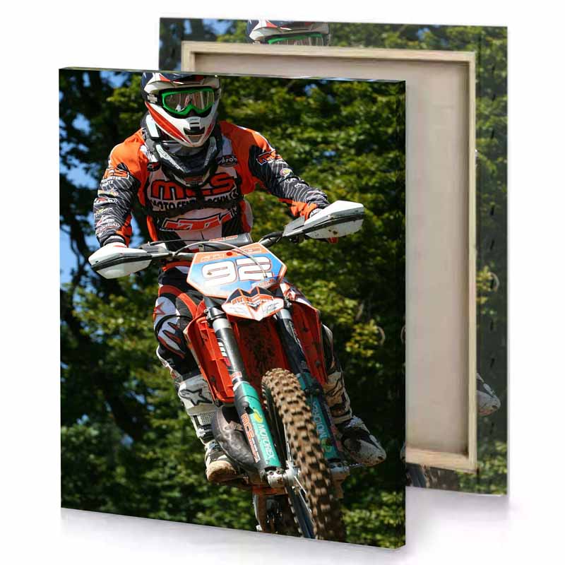 a man riding dirt bike on track bistre canvas