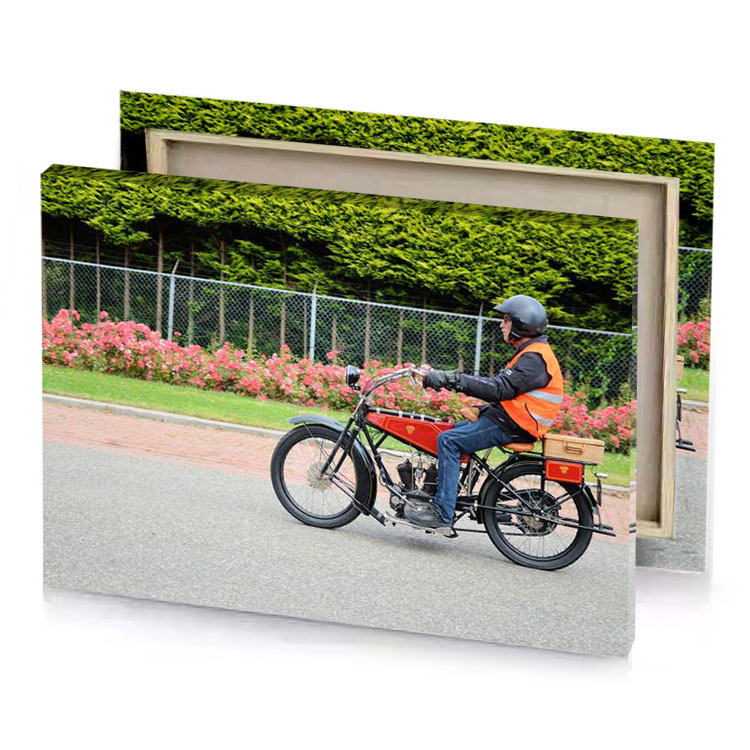 a man riding motorcycle down street rosy brown canvas