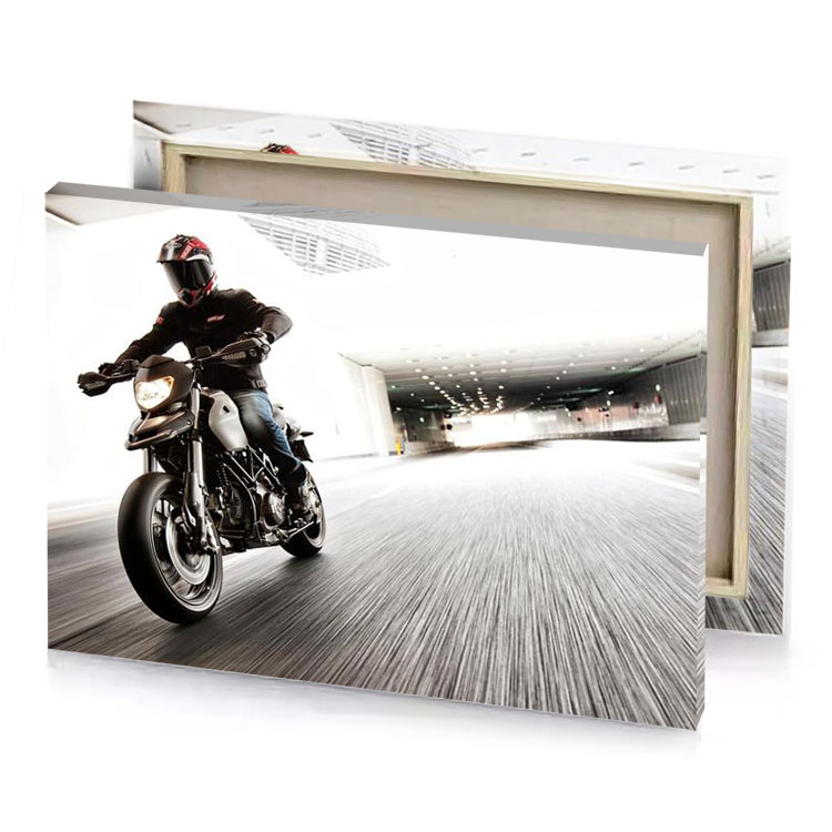 a man riding motorcycle down street smoky black canvas