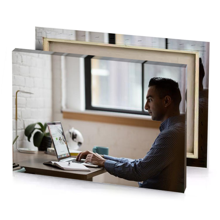a man sitting at desk using laptop silver canvas