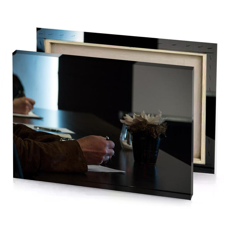 a man sitting at table writing on piece of paper smoky black canvas