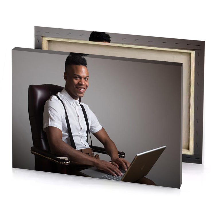 a man sitting in chair with laptop gray canvas