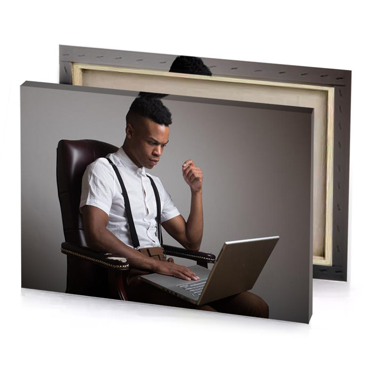 a man sitting in chair with laptop smoky black canvas