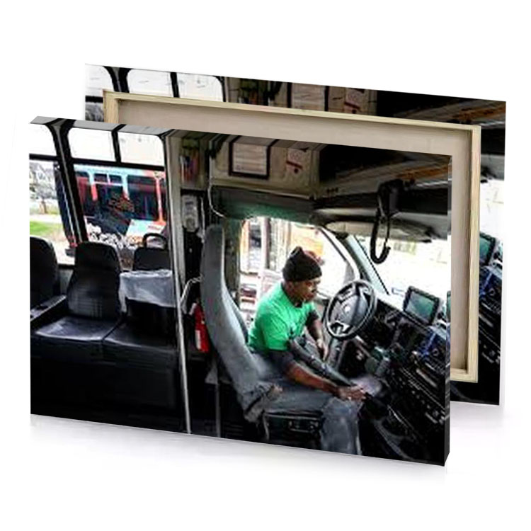 a man sitting in the driver s seat of bus medium aquamarine canvas