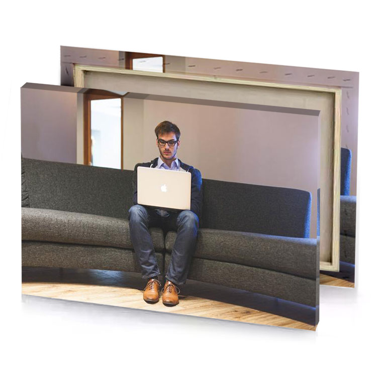a man sitting on couch using laptop taupe canvas