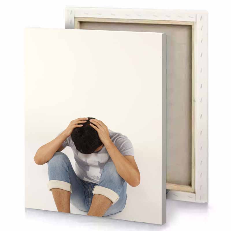 a man sitting on the floor with his head in linen canvas