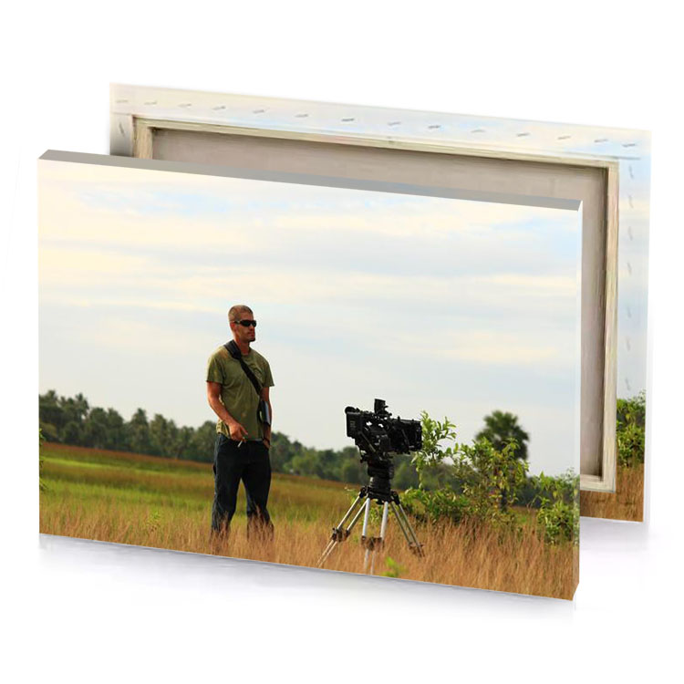 a man standing in field with camera bistre canvas