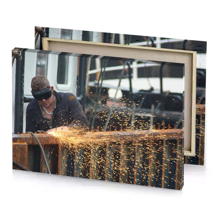 a man welding piece of wood fawn canvas