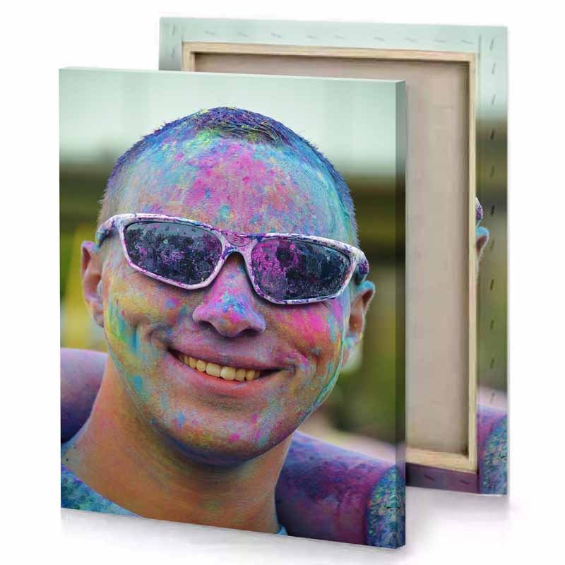 a man with face full of colored powder charcoal canvas