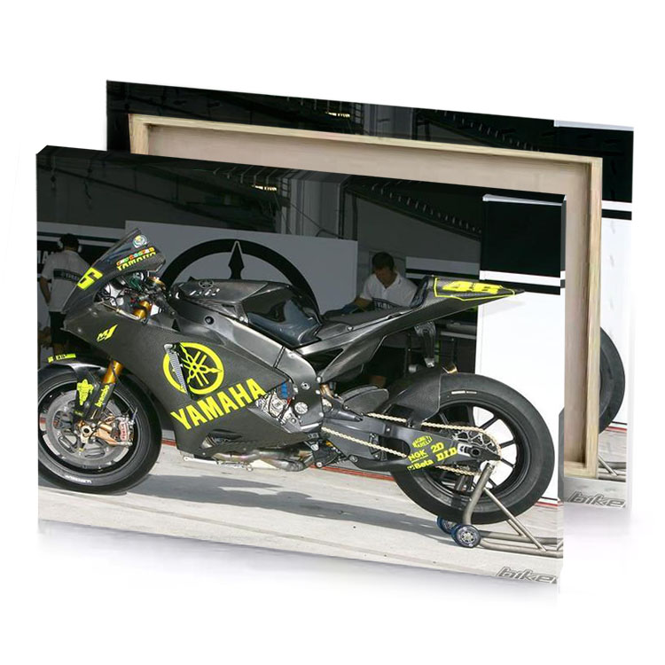 a motorcycle parked in front of building charcoal canvas