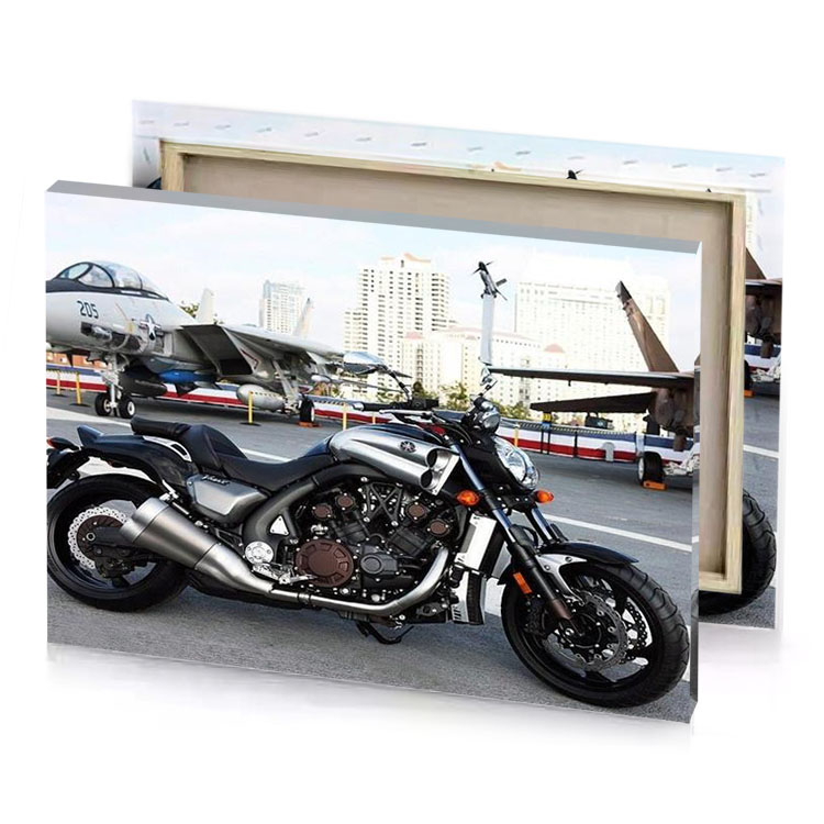 a motorcycle parked on the street next to an airplane smoky black canvas