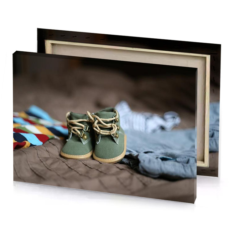 a pair of baby shoes on bed light steel blue canvas