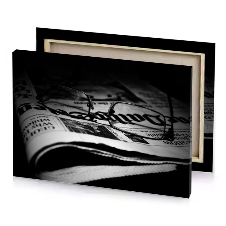 a pair of glasses laying on top newspaper platinum canvas